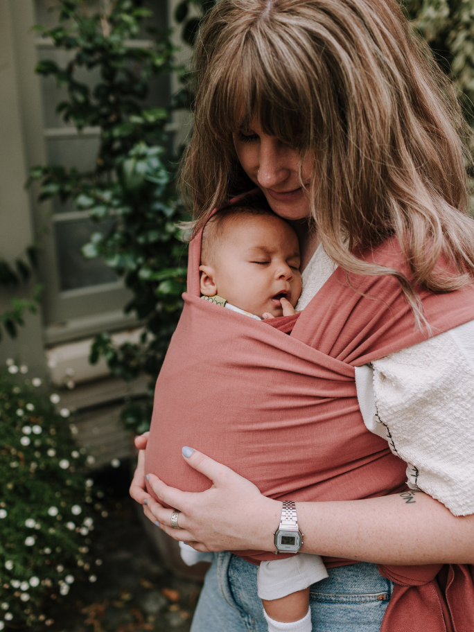 Mum wearing baby is a pink boba carrier