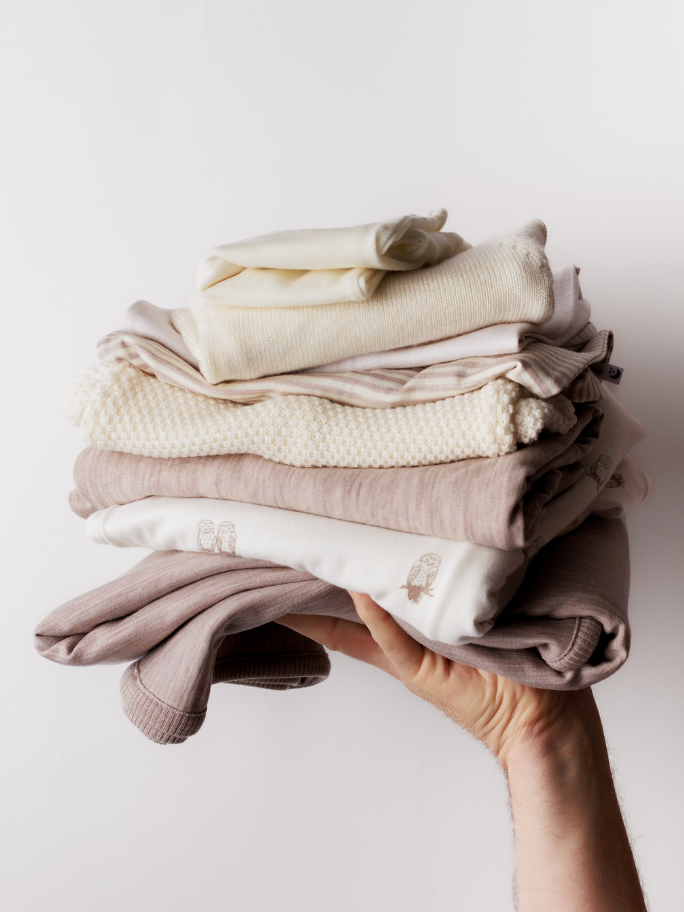 Stack of beige and cream coloured merino items