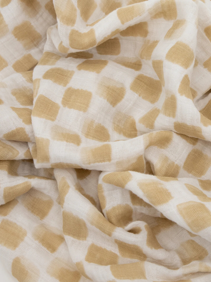 Close up of muslin swaddle in a brown check