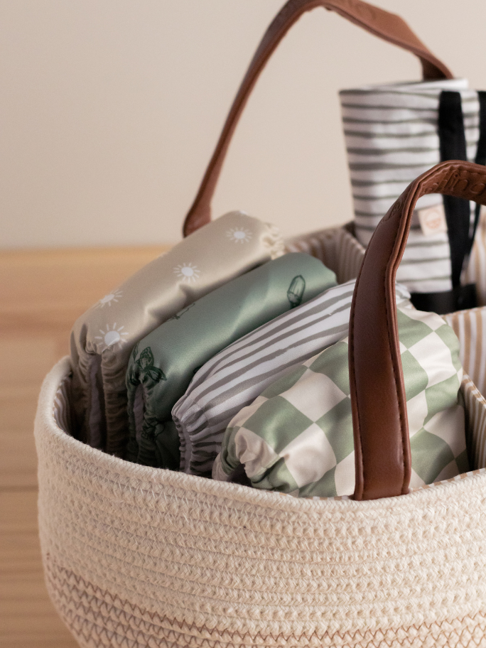 Selection of modern cloth nappies in a nappy caddy