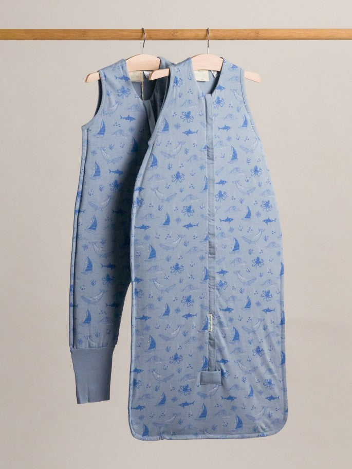 A duvet sleeping bag and sleeping suit in glacier sailboat hanging on a rack