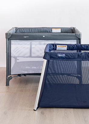 Two different portacot travel cots against a plain background
