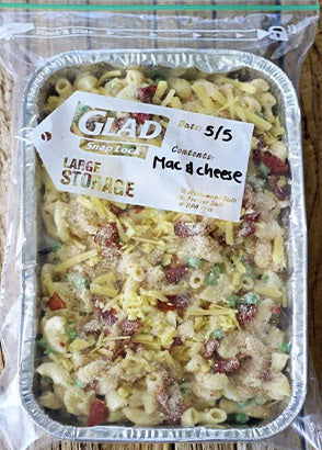Mac and cheese meal in oven tray and plastic bag for freezer