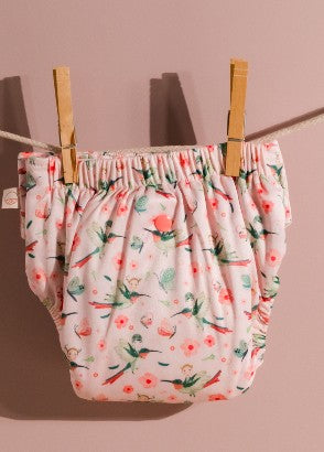 Modern cloth nappy hanging on washing line with pegs wash routines for reusable cloth nappies