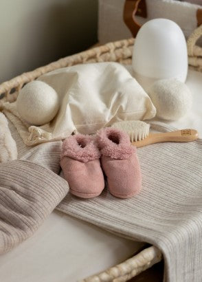 Selection of baby items including woolen booties, dryer balls and sound machine