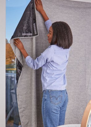 Purflo total eclipse blackout blind being hung above a window in a nursery