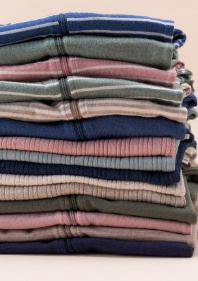 Stack of the sleep store and Woolbabe merino garments