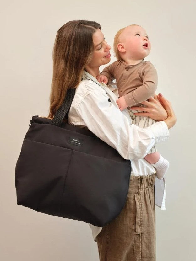 Dad carrying toddler wearing Nappy Bag Backpack on his back