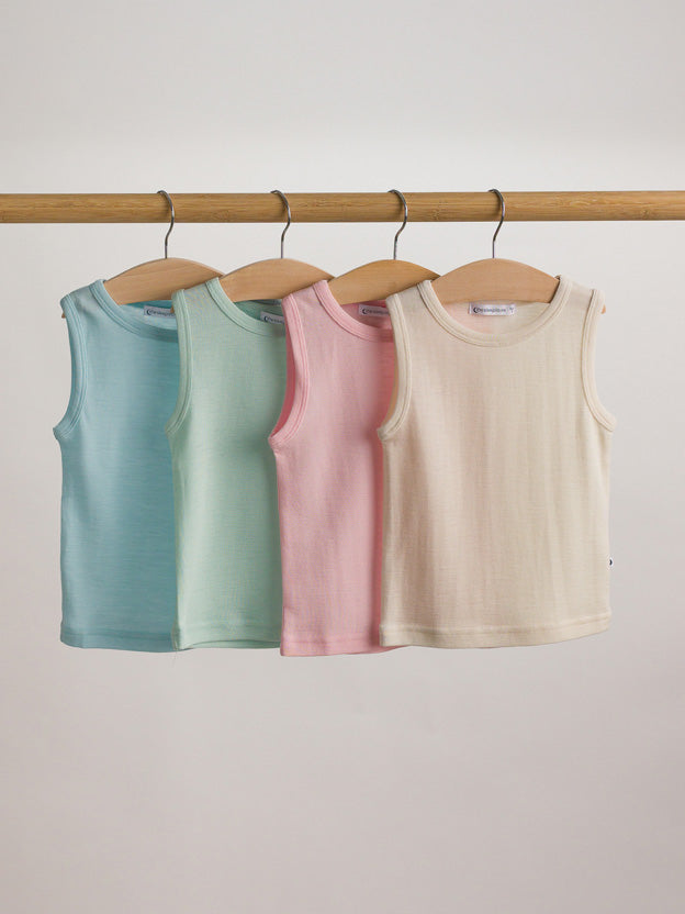 Row of four pastel coloured singlets hanging on a wooden rack