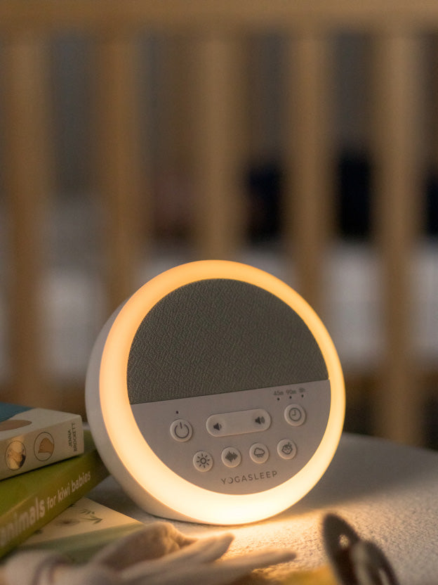 Yogasleep Nod White Noise Machine on a desk in a nursery setting