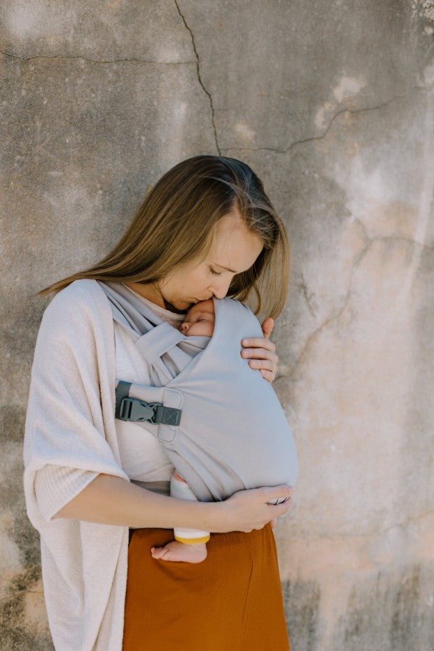 Woman carrying baby in a charcoal boba stretchy wrap