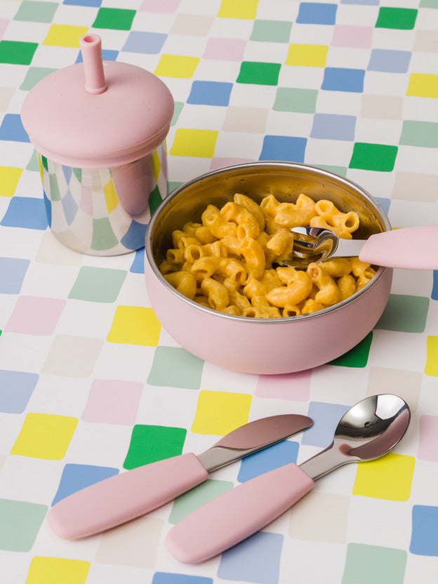 Stainless Steel Baby Bowl in pink with cutlery on a bright cloth