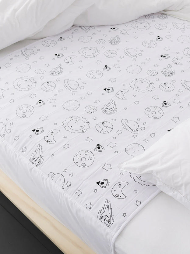 space themed drawings on a white brolly sheets mattress protector on a single bed