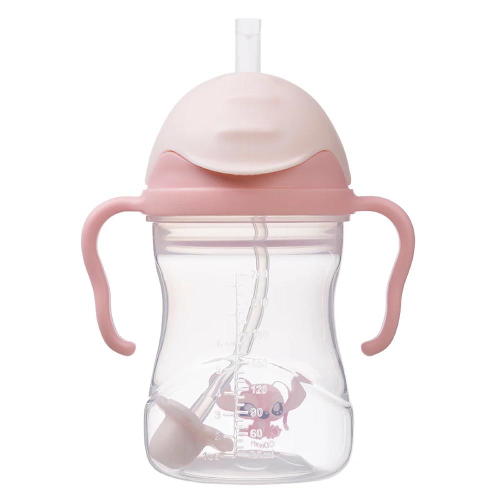 Pink sippy cup with straw and handles on a white background