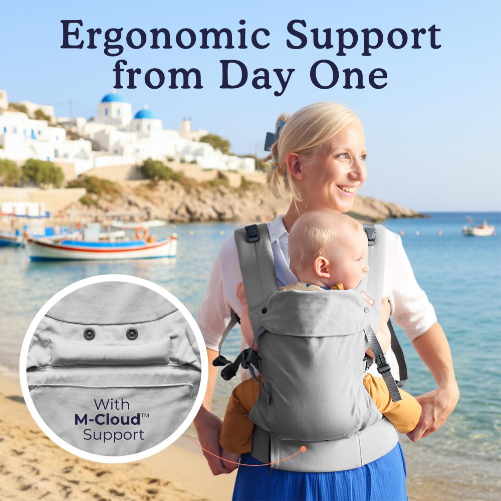 Grey Beco Gemini V2 Baby Carrier on a woman at the beach