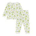 Child in cotton apple print pyjamas on a white background