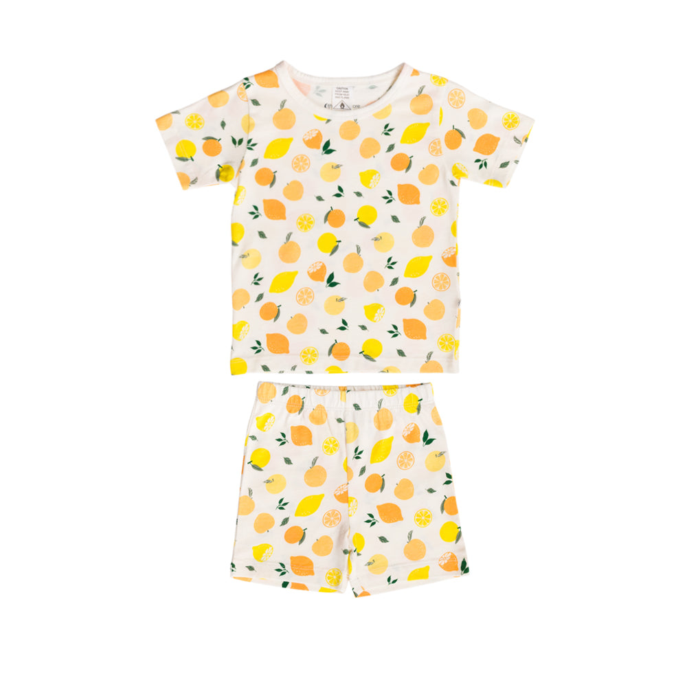 A two-piece kids' short-sleeve set featuring a cream-colored t-shirt and shorts with an all-over lemon and orange print, displayed flat against a solid white background.