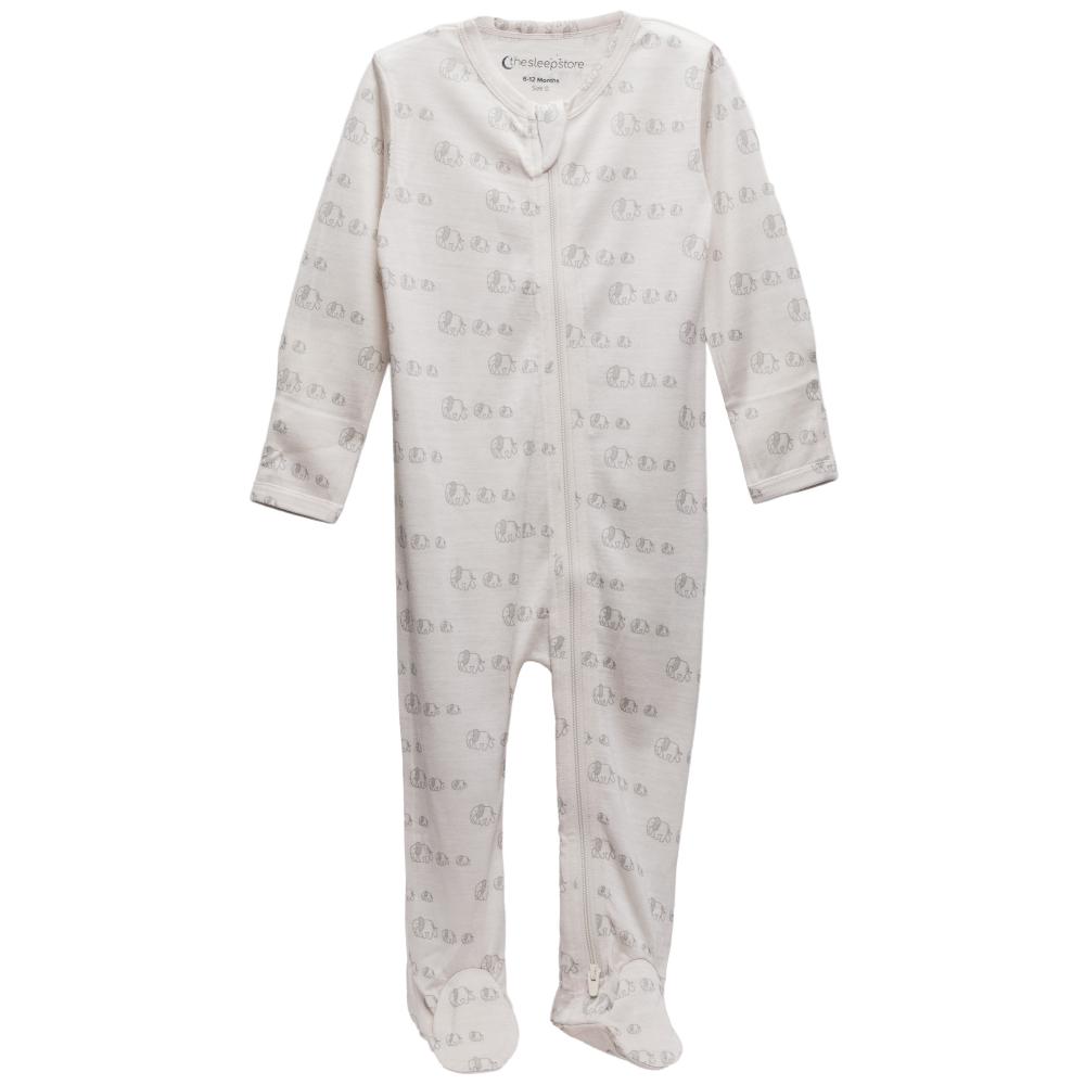 Cream with elephant print footed merino zipsuit on a white background