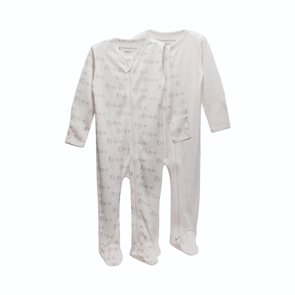 2 footed merino zipsuits, one cream, one cream with elephants on a white background
