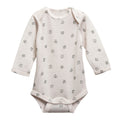 Cream with leaf print merino long sleeve bodysuit on a white background