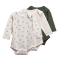 3 pack of long sleeve merino bodysuits in cream, green and leaves print on a white background