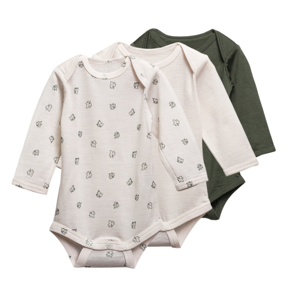 3 pack of long sleeve merino bodysuits in cream, green and leaves print on a white background