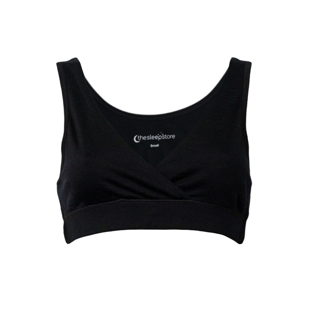 A black sleep bra with a crossover wrap front and wide shoulder straps, shown flat on a white background. The brand name The Sleep Store is printed inside the neckline.