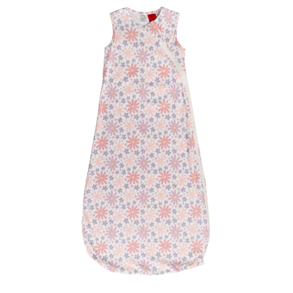 A sleeveless cotton baby sleep sack with a repeating floral snowflake pattern in pink, purple, and blue on a white background, shown flat against a white background.