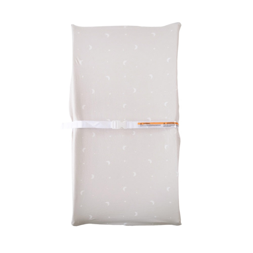 Beige baby change pad cover with a subtle pattern on a white background