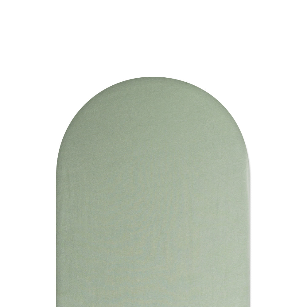 Green fitted sheet on white background