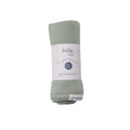 Folded green baby swaddle blanket with 'The Sleep Store' label on a white background