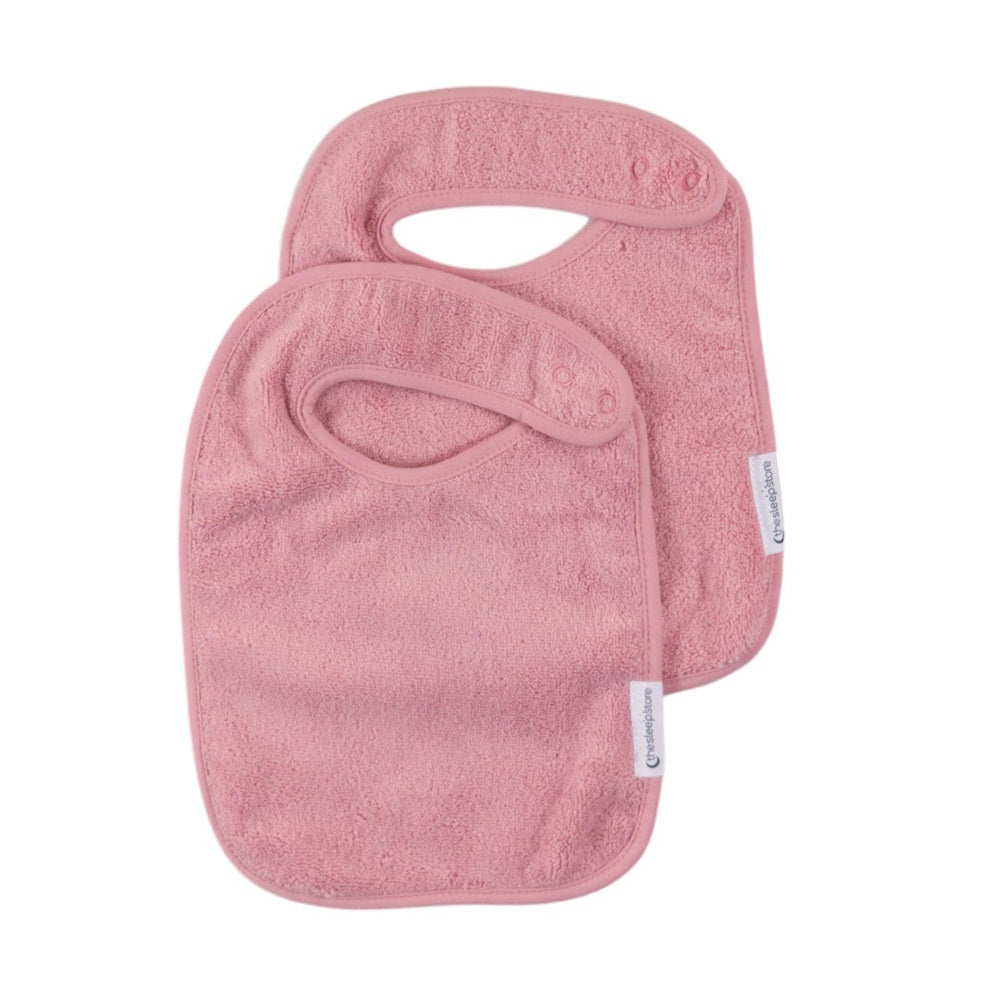 Two pink baby bib's on a white background