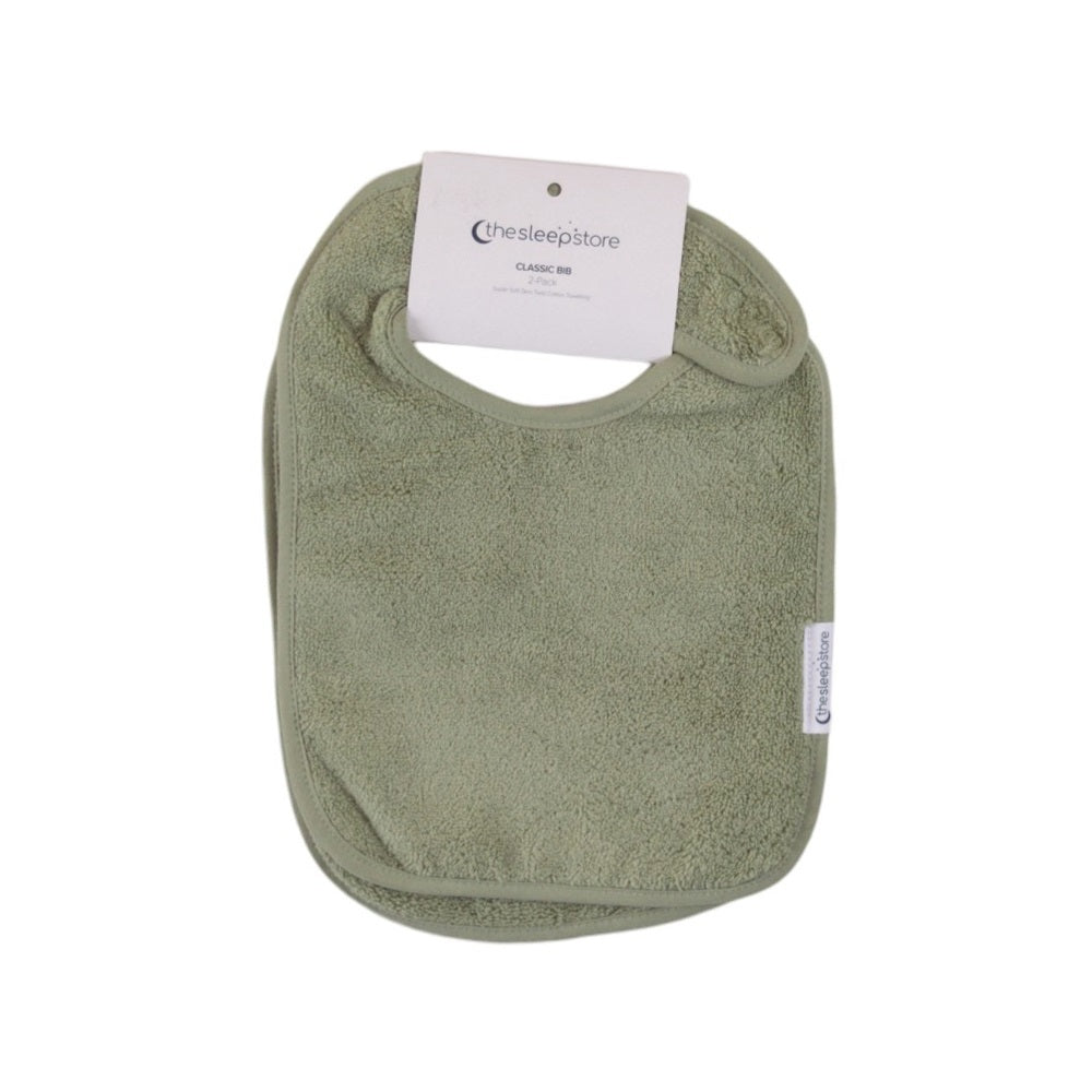 Green terry cotton baby bib with a label on a white background