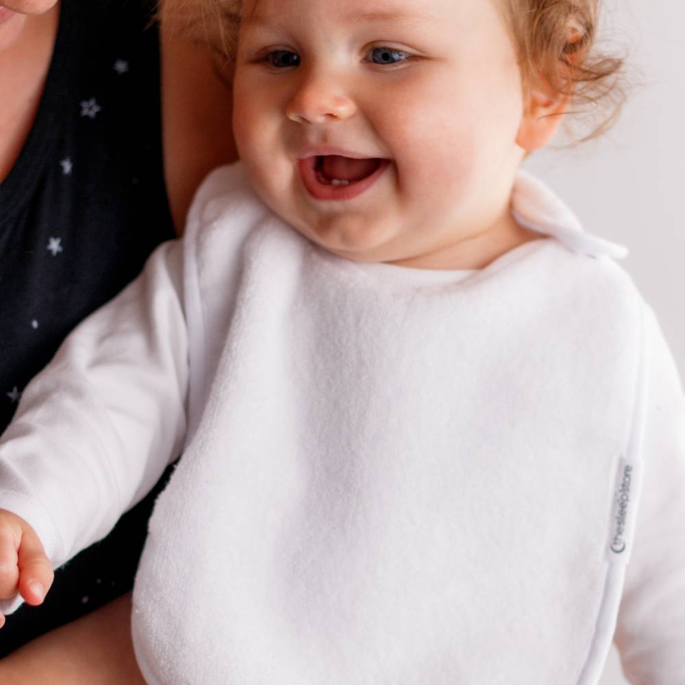 Baby wearing white bib