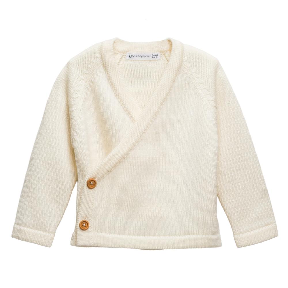 Cream-colored merino wool knitted baby kimono cardigan with buttons on a white background