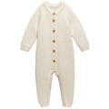 Cream merino wool Knitted baby onesie with button details on a white background
