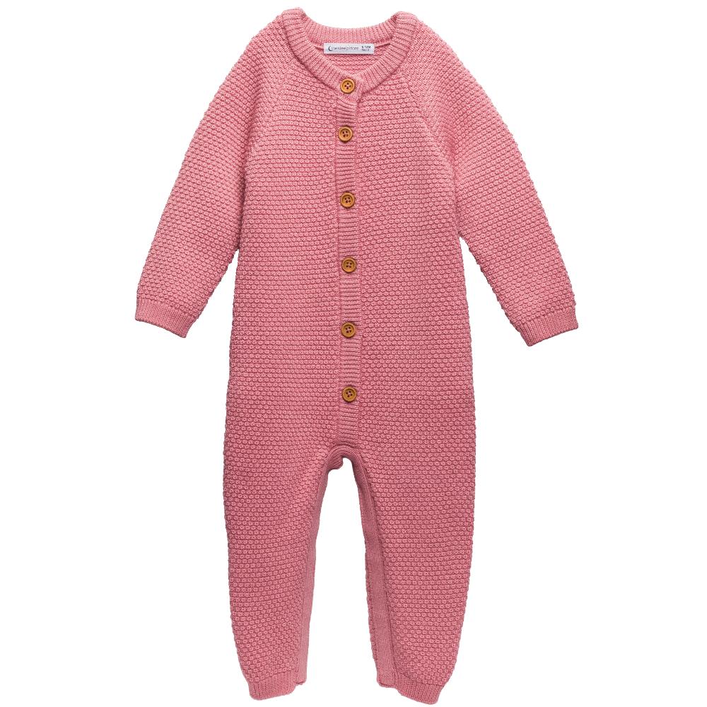 Pink merino wool knitted baby onesie with brown buttons on the front against a white background