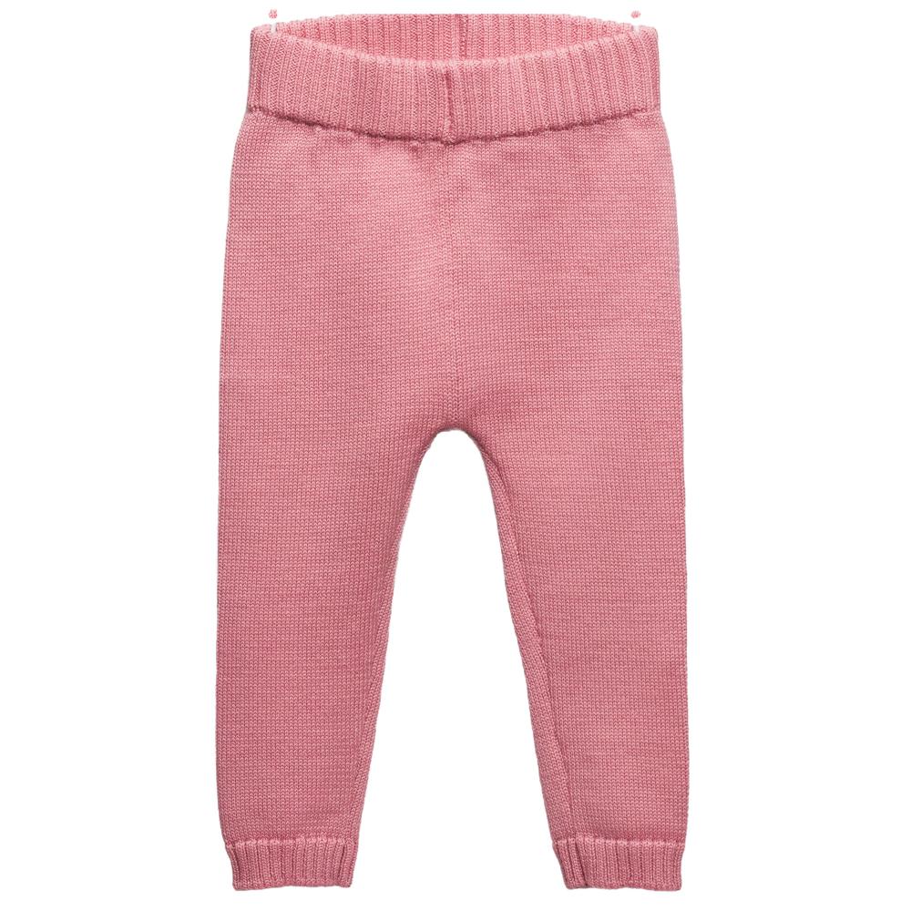 Pink merino wool knitted baby pants on a white background