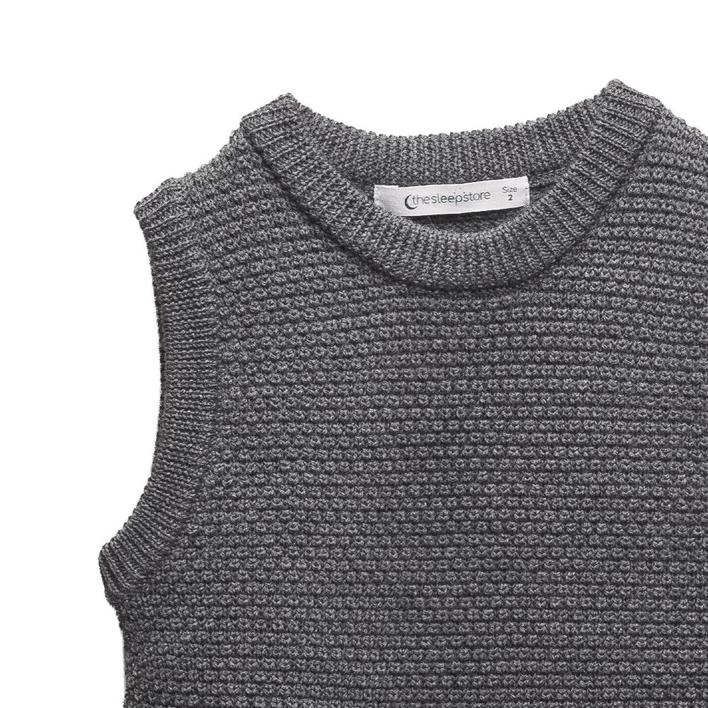 Grey knitted sleeveless sweater vest with a 'The Sleep Store' brand label on a white background