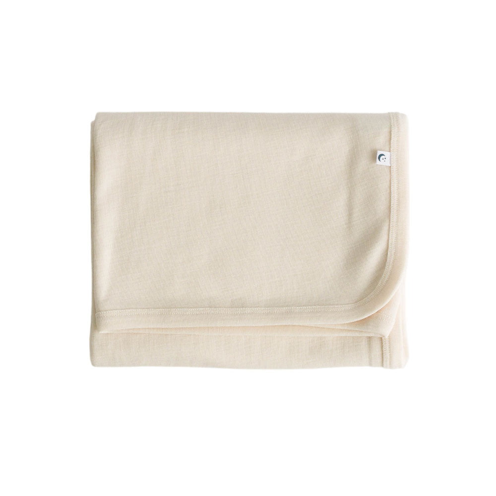 Cream deluxe rib merino swaddle blanket with a brand logo on a white background
