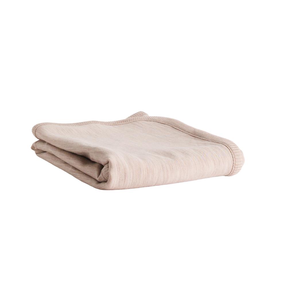 A folded light beige knit blanket with a ribbed border, shown on a plain white background.