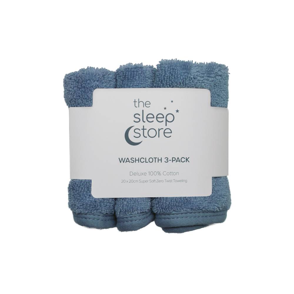 Three blue cotton terry washcloths in a package with 'The Sleep Store' label on a white background