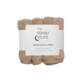 Three beige washcloths wrapped together with a label from 'the sleep store' on a white background.