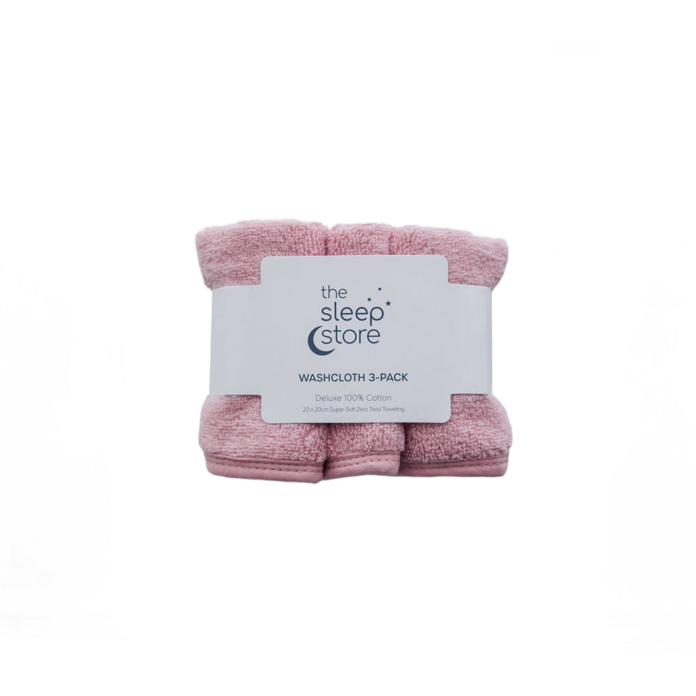 Three pink cotton terry washcloths in a bundle with a label from 'the sleep store' on a white background.