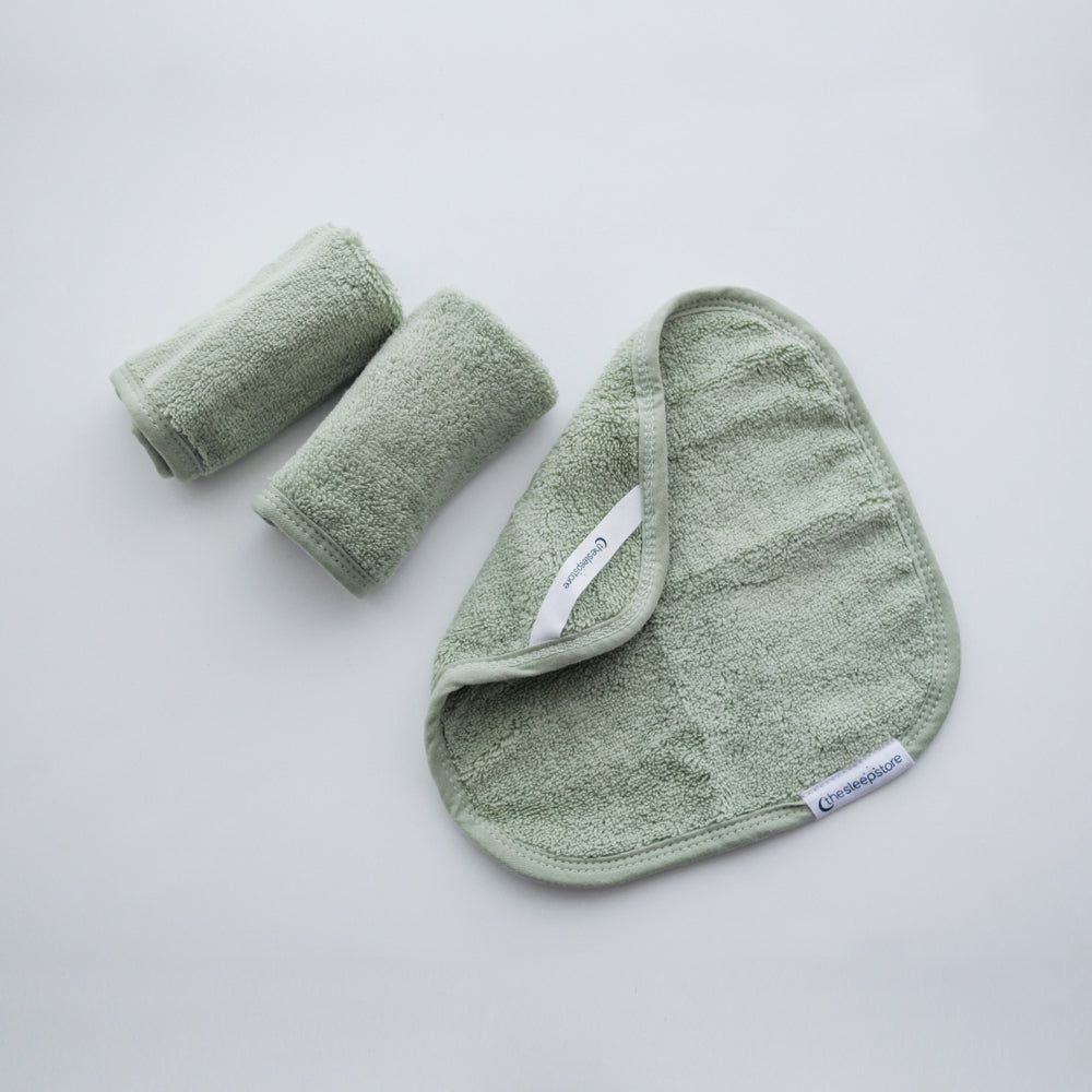 Set of 3 green cotton terry cloths on a light gray background