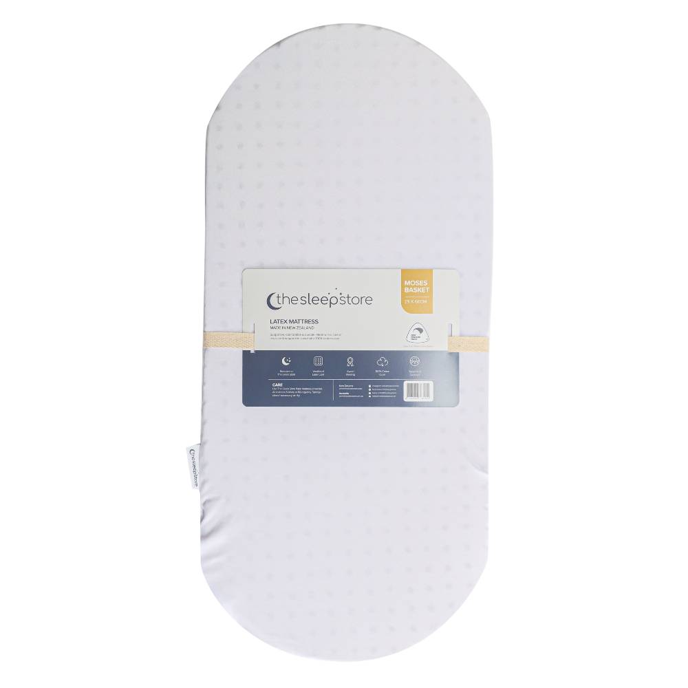 White latex moses basket mattress with 'The Sleep Store' label on a white background