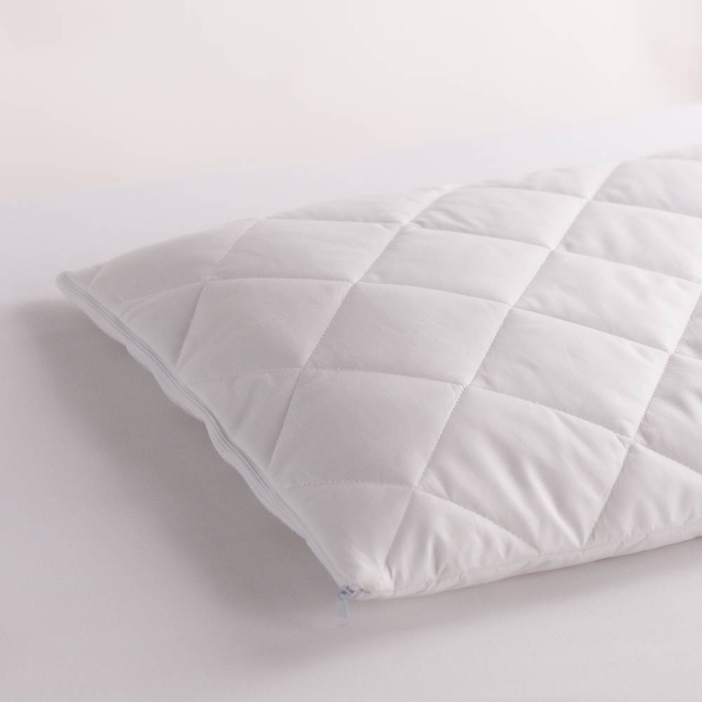 White quilted pillow on a light gray background