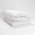 White Duvet Inner rolled up on a white background