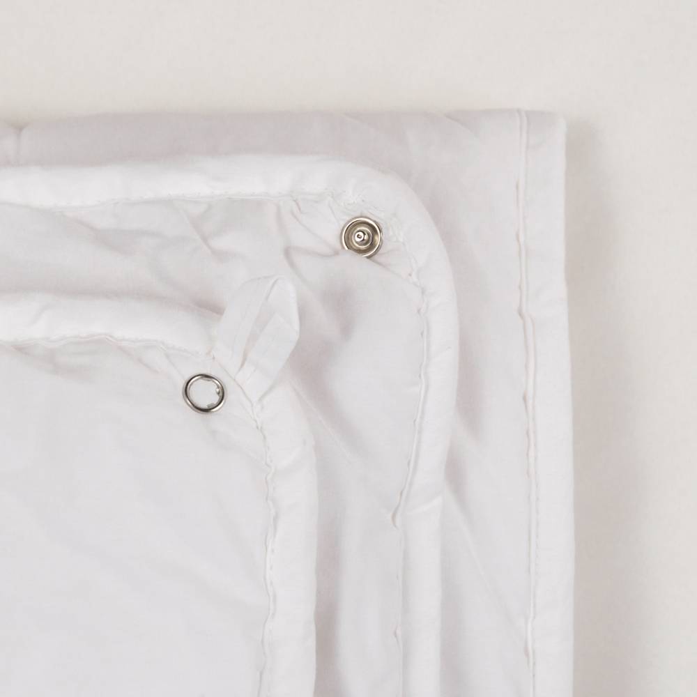 White Duvet Inner rolled up on a white background