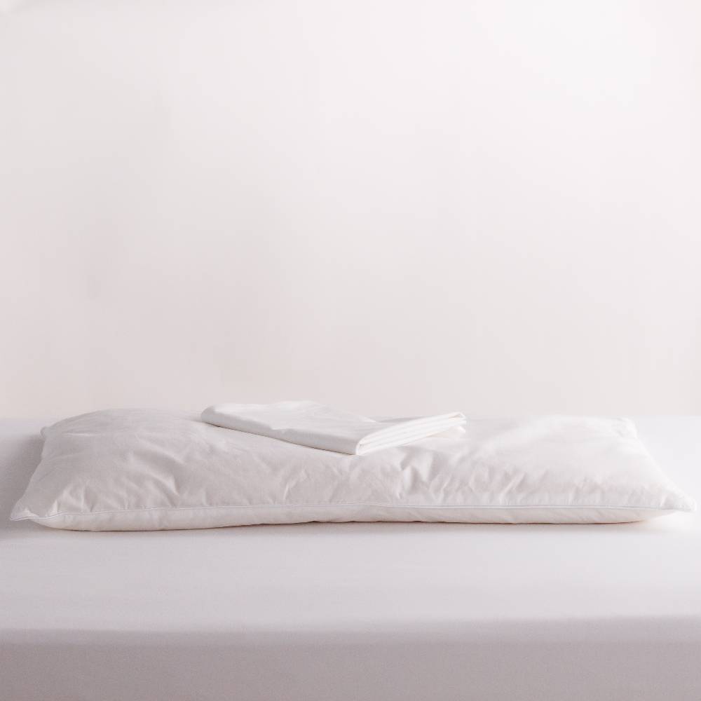 Wool pillow with pillowcase on top on white background